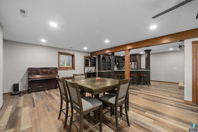 48190 265th St, Brandon, SD 57005 - dining space featuring light wood finished floors, recessed lighting, a ceiling fan, bar, and decorative columns