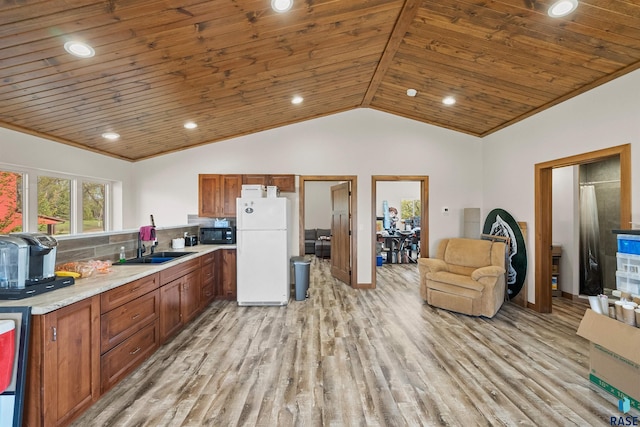 48190 265th St, Brandon, SD 57005 - kitchen featuring freestanding refrigerator, black microwave, wood ceiling, light wood finished floors, and a sink