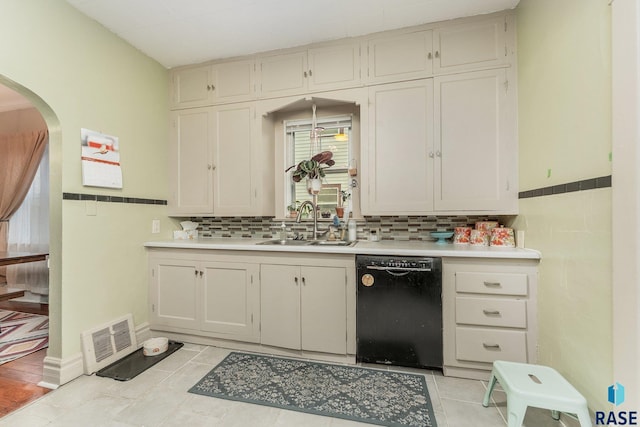 805 S Spring Ave, Sioux Falls, SD 57104 - kitchen featuring black dishwasher, arched walkways, light countertops, and a sink