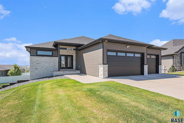 8209 E Ladyslipper Cir, Sioux Falls, SD 57110 - prairie-style house featuring an attached garage, driveway, and stone siding