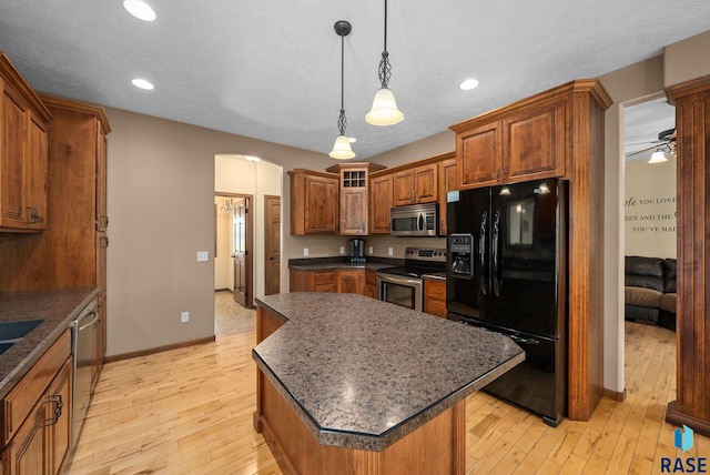 2305 N Ivy Rd, Tea, SD 57064 - kitchen featuring appliances with stainless steel finishes, a kitchen island, light wood-type flooring, brown cabinetry, and recessed lighting