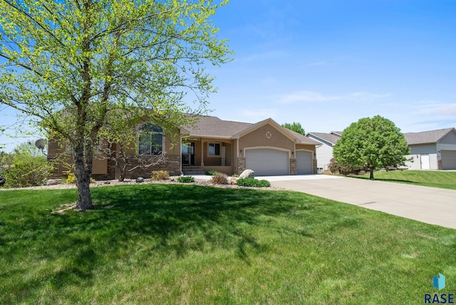 2305 N Ivy Rd, Tea, SD 57064 - ranch-style home featuring a garage, driveway, a front yard, stone siding, and stucco siding