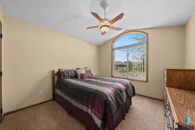 2305 N Ivy Rd, Tea, SD 57064 - bedroom with light carpet, vaulted ceiling, baseboards, a ceiling fan, and a textured ceiling
