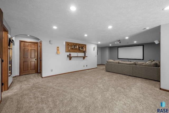 2305 N Ivy Rd, Tea, SD 57064 - carpeted home theater room with arched walkways, a textured ceiling, baseboards, and recessed lighting