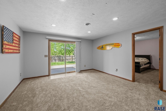 2305 N Ivy Rd, Tea, SD 57064 - spare room with carpet, baseboards, a textured ceiling, and recessed lighting