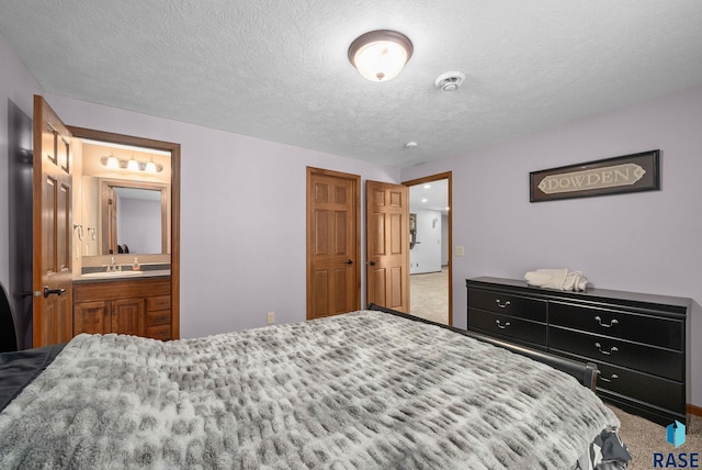 2305 N Ivy Rd, Tea, SD 57064 - bedroom featuring carpet, a textured ceiling, a sink, and ensuite bath