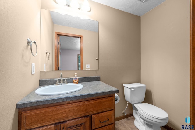 2305 N Ivy Rd, Tea, SD 57064 - half bath featuring toilet, vanity, baseboards, and a textured ceiling