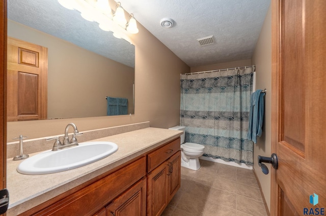 2305 N Ivy Rd, Tea, SD 57064 - bathroom with toilet, vanity, tile patterned floors, and a textured ceiling