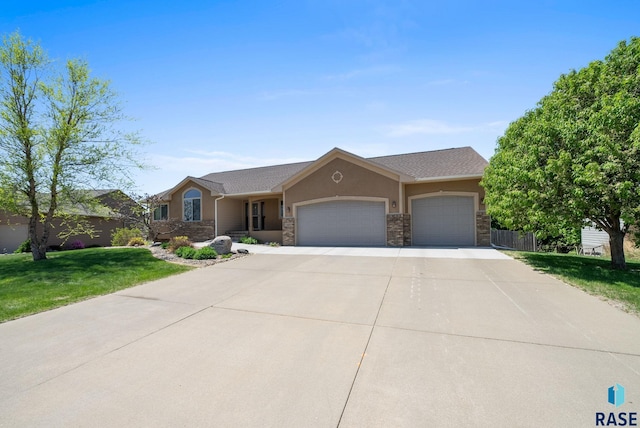 2305 N Ivy Rd, Tea, SD 57064 - single story home featuring a garage, driveway, stone siding, and stucco siding