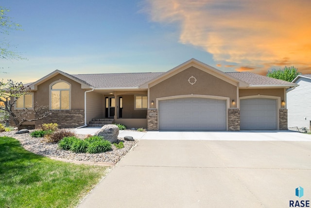 2305 N Ivy Rd, Tea, SD 57064 - ranch-style house featuring a garage, driveway, and stucco siding