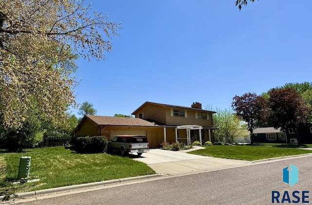 traditional home with a chimney, concrete driveway, and a garage