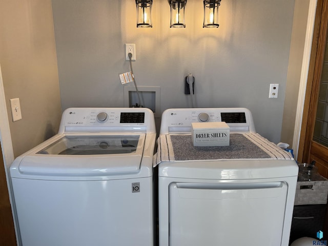 clothes washing area featuring washer and dryer