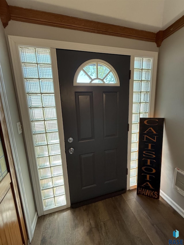 foyer entrance with dark wood-style floors and baseboards