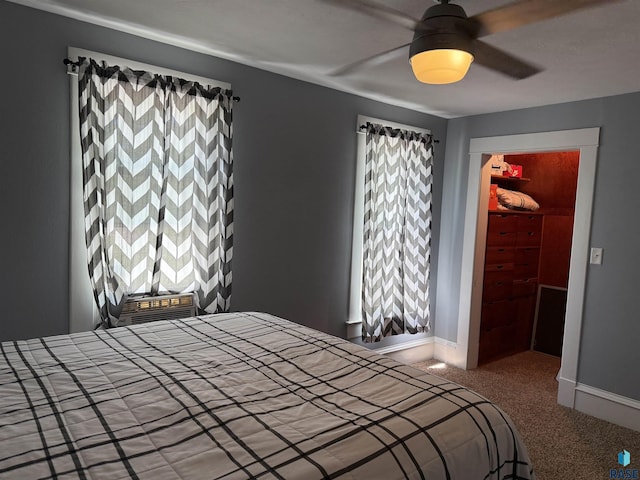 carpeted bedroom featuring multiple windows, baseboards, and ceiling fan