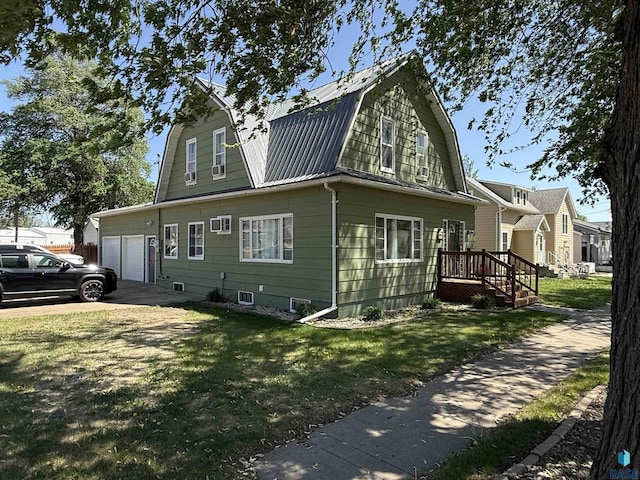 view of front facade featuring a gambrel roof, a front lawn, metal roof, a garage, and a deck