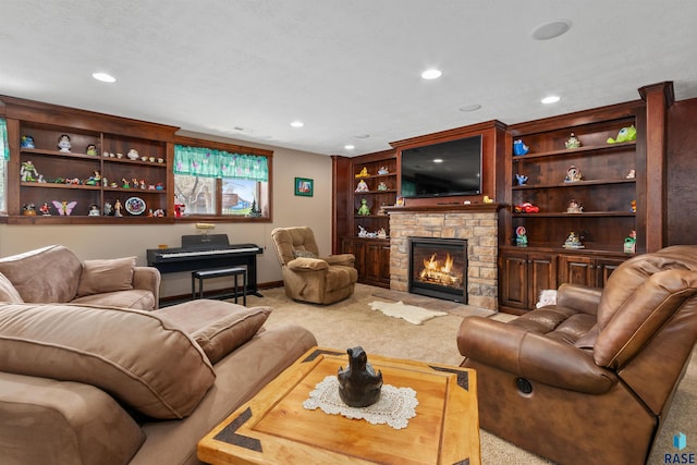 living room with carpet, recessed lighting, a stone fireplace, baseboards, and built in shelves