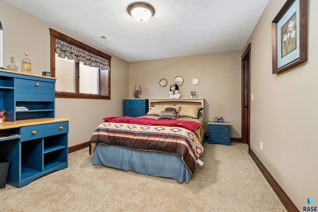 bedroom featuring carpet, a textured ceiling, and baseboards