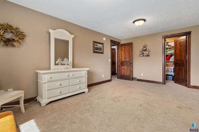 bedroom featuring light carpet and baseboards