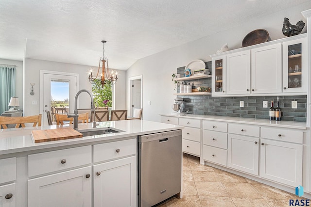 46370 237th St, Wentworth, SD 57075 - kitchen with stainless steel dishwasher, backsplash, light countertops, white cabinetry, and hanging light fixtures