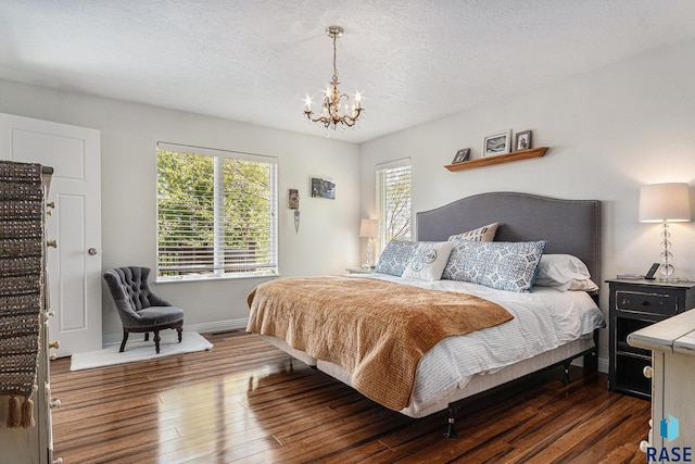 46370 237th St, Wentworth, SD 57075 - bedroom with a chandelier, wood finished floors, baseboards, and a textured ceiling