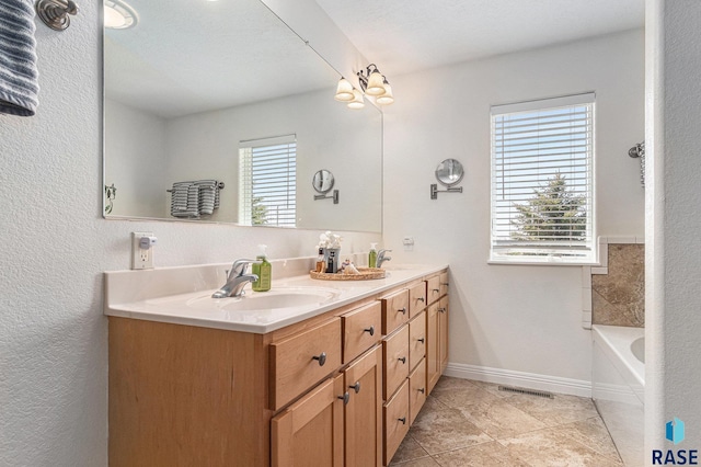 46370 237th St, Wentworth, SD 57075 - bathroom featuring double vanity, baseboards, a tub, and tile patterned floors