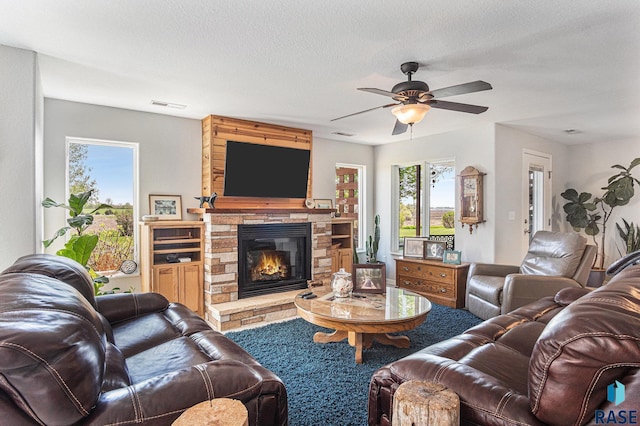 46370 237th St, Wentworth, SD 57075 - living room with a ceiling fan, a fireplace, and plenty of natural light