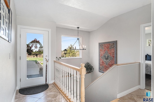 46370 237th St, Wentworth, SD 57075 - entryway featuring light tile patterned floors, a chandelier, baseboards, and lofted ceiling