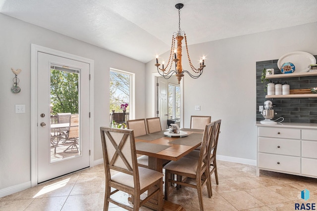 46370 237th St, Wentworth, SD 57075 - dining space with lofted ceiling, a chandelier, baseboards, light tile patterned floors, and a textured ceiling