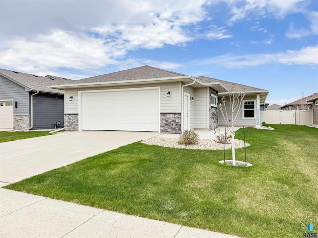 8612 W Dalton St, Sioux Falls, SD 57106 - prairie-style house featuring driveway, an attached garage, stone siding, and a shingled roof