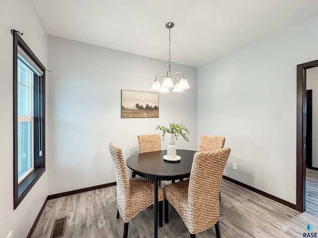 8612 W Dalton St, Sioux Falls, SD 57106 - dining space with light wood-type flooring, baseboards, and a chandelier