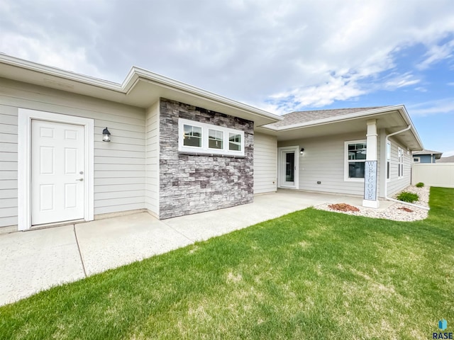 8612 W Dalton St, Sioux Falls, SD 57106 - rear view of house with a lawn and a patio area