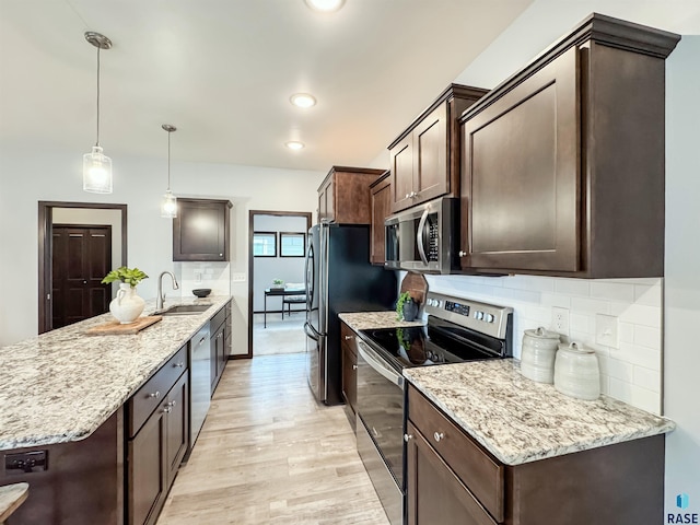 8612 W Dalton St, Sioux Falls, SD 57106 - kitchen featuring stainless steel appliances, a sink, dark brown cabinets, a peninsula, and tasteful backsplash