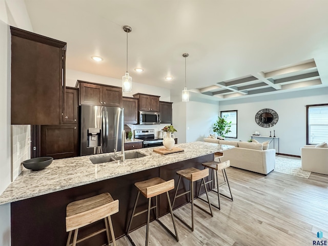 8612 W Dalton St, Sioux Falls, SD 57106 - kitchen with appliances with stainless steel finishes, a sink, dark brown cabinetry, a kitchen breakfast bar, and coffered ceiling