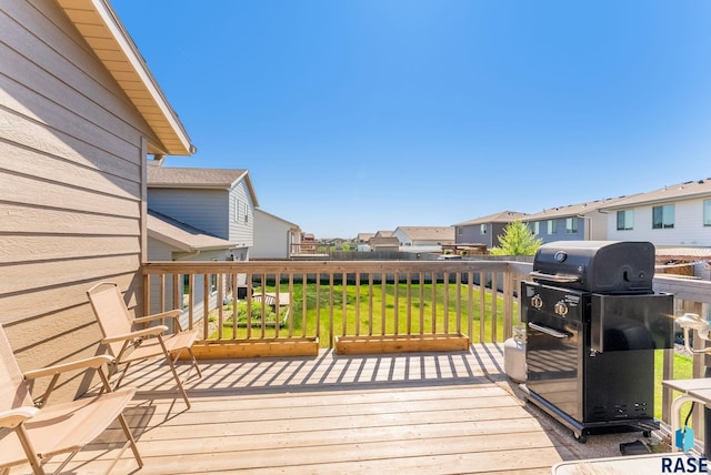wooden deck featuring a residential view, area for grilling, and a yard