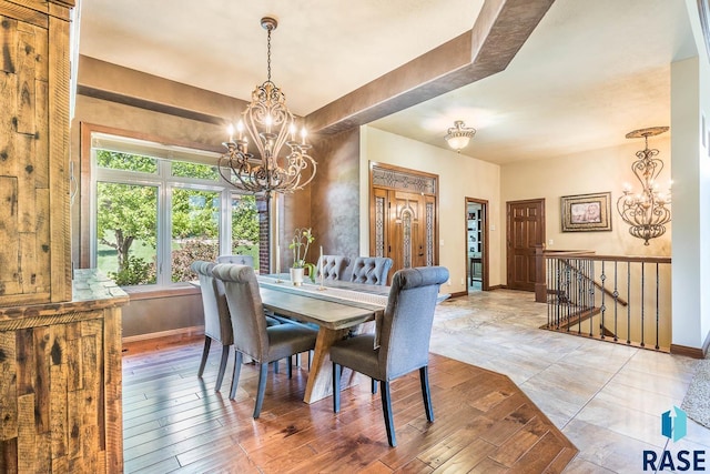 dining room with a chandelier and baseboards