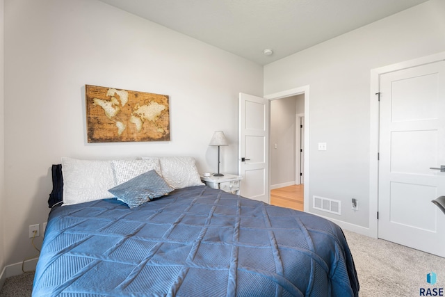 bedroom with carpet flooring and baseboards