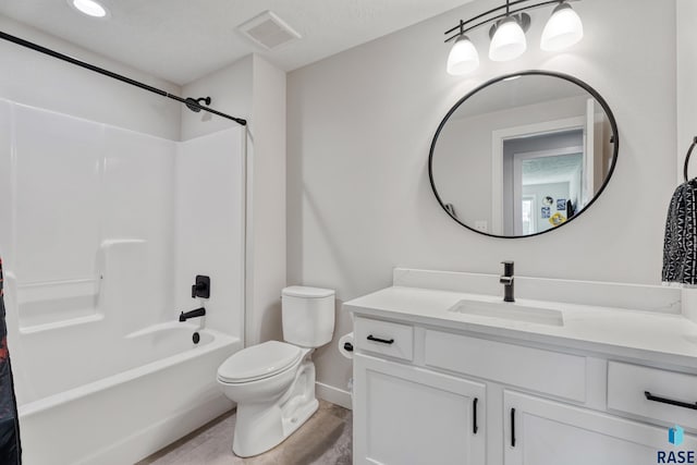 bathroom with toilet, vanity, tub / shower combination, and baseboards