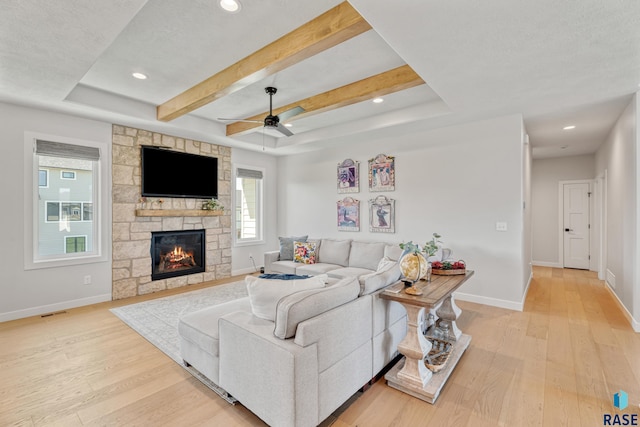 living area with a stone fireplace, light wood-type flooring, baseboards, recessed lighting, and ceiling fan
