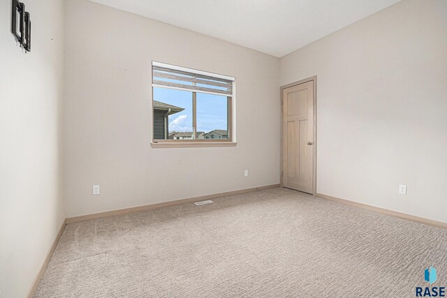 2629 S Richie Dr, Sioux Falls, SD 57106 - spare room featuring light carpet and baseboards