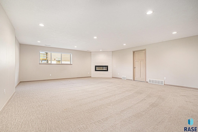 2629 S Richie Dr, Sioux Falls, SD 57106 - unfurnished living room featuring recessed lighting, light carpet, baseboards, and a fireplace