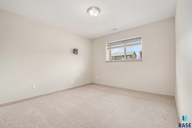 2629 S Richie Dr, Sioux Falls, SD 57106 - carpeted spare room featuring baseboards and a textured ceiling