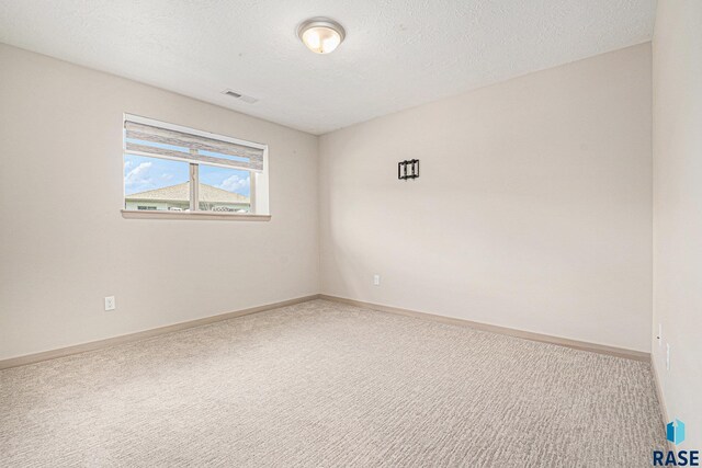 2629 S Richie Dr, Sioux Falls, SD 57106 - carpeted empty room with baseboards and a textured ceiling