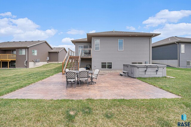 2629 S Richie Dr, Sioux Falls, SD 57106 - rear view of property featuring a hot tub, stairway, a patio area, and a lawn
