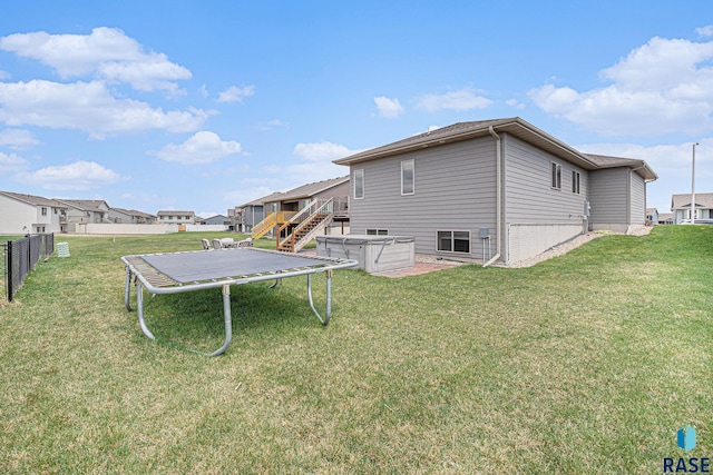 2629 S Richie Dr, Sioux Falls, SD 57106 - back of property featuring a trampoline, stairway, a deck, and a residential view
