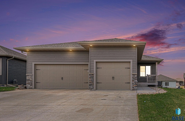 2629 S Richie Dr, Sioux Falls, SD 57106 - view of front of property featuring a garage, driveway, roof with shingles, and stone siding