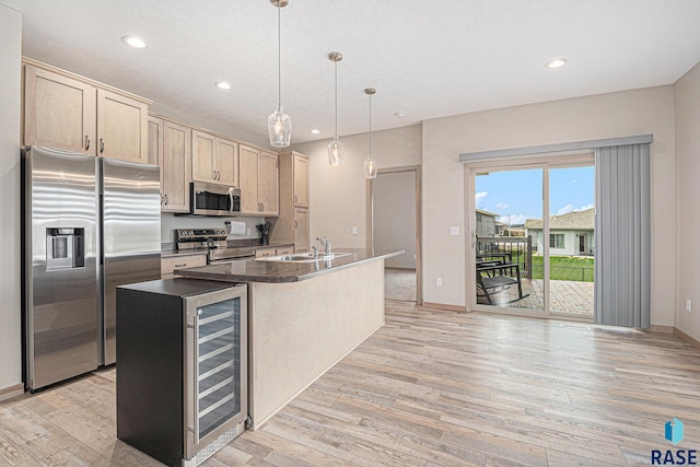 2629 S Richie Dr, Sioux Falls, SD 57106 - kitchen with appliances with stainless steel finishes, light wood-style floors, recessed lighting, a sink, and an island with sink