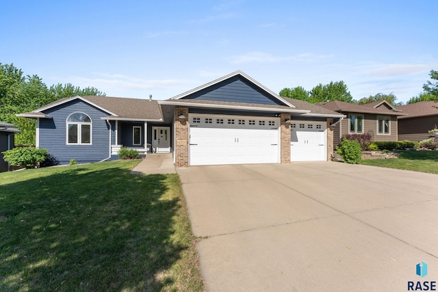 4201 S Pillsbury Ave, Sioux Falls, SD 57103 - ranch-style house with driveway, a front yard, a garage, and brick siding