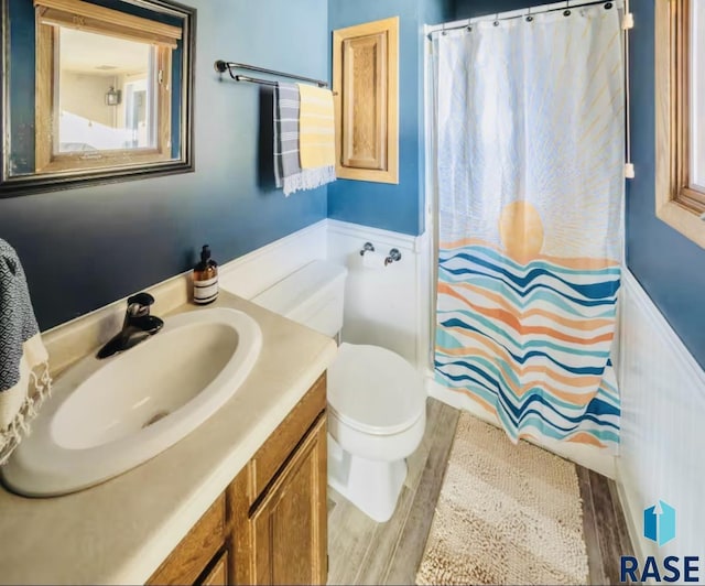 2304 S Mockingbird Cir, Sioux Falls, SD 57103 - full bathroom with wood finished floors, vanity, curtained shower, and toilet