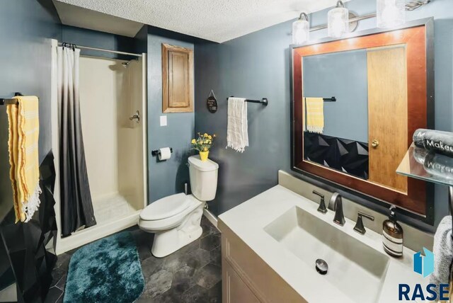 2304 S Mockingbird Cir, Sioux Falls, SD 57103 - full bathroom featuring a stall shower, toilet, a textured ceiling, and vanity