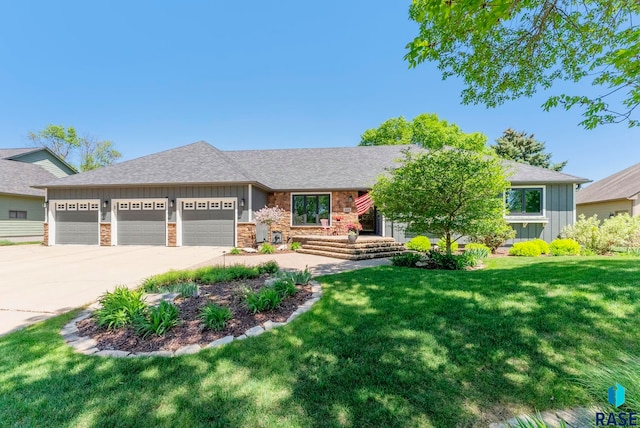 408 N Oak Ridge Rd, Brandon, SD 57005 - view of front facade featuring board and batten siding, a garage, stone siding, a front lawn, and driveway